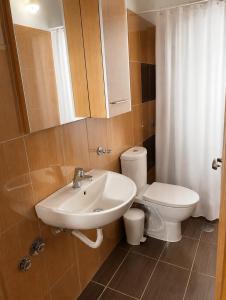a bathroom with a sink and a toilet at Hotel Olivia in Agiokampos +2 photos