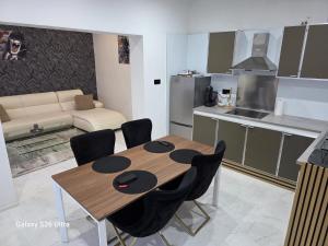 a kitchen and dining room with a wooden table and chairs at Fleurus House in Fleurus