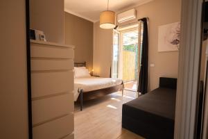 a small bedroom with a bed and a window at Country Resort Le Due Ruote in Alberese +106 photos
