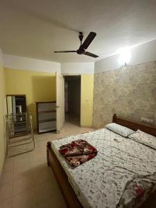 a bedroom with a bed with a ceiling fan at ChriSeph in Kottayam