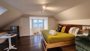 a bedroom with a bed and a table and a couch at Les Suites Du Vieux-Lévis - With AC and Parking in Lévis +16 photos