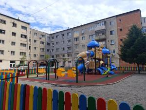 a playground in front of a building at Mim's Home in Băile Herculane