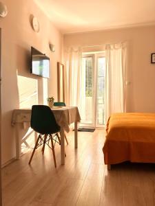 a bedroom with a desk and a bed and a table at Lenka Apartments I in Novalja