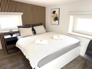 a bedroom with a bed with two towels on it at APARTMÁNY za divadlem in Broumov