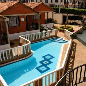 a large swimming pool with a wooden rail around it at Hotel Aguablanca in La Mesa +5 photos