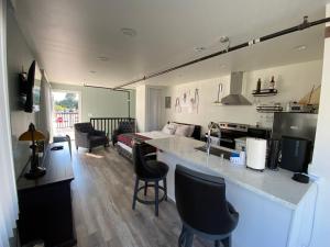 a kitchen with a counter and a living room at Soundview Ferry Cottage in Mukilteo