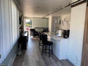 a kitchen with a counter and chairs in a room at Soundview Ferry Cottage in Mukilteo