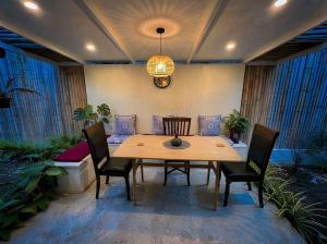 a dining room table with chairs and a chandelier at The Arya Srithanu in Ko Kong Nui