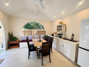 a kitchen and dining room with a table and chairs at The Arya Srithanu in Ko Kong Nui