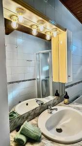 a bathroom with a sink and a mirror at Border Bridge House in Tui