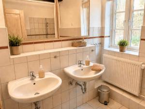 a bathroom with two sinks and a mirror at Alte Faktorei Schierke in Schierke +47 photos