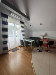 a living room with a table and chairs at Apartament Łeba in Żarnowska