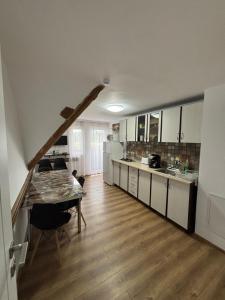 a kitchen with a table and a dining room at Casa Sofia Dorna Candrenilor in Dorna Cîndrenilor