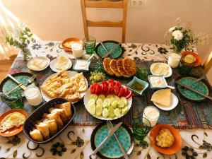 a table topped with plates of food on a table at Ivlita in Mestia