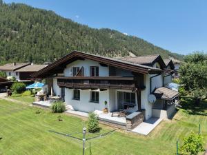 a house with a mountain in the background at Active Apart Central in Ried im Oberinntal