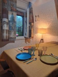 a table with a blue plate on top of it at Chalet Etna dreamers in Nicolosi +32 photos