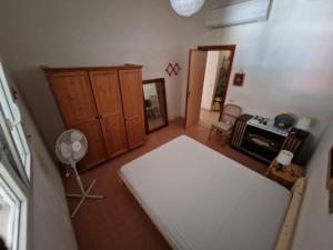 a living room with a table and a cabinet at Villino Irmgard in Butera