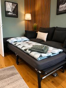 a large bed in a living room with a couch at Haus Madeleine in Schönwald