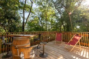 a wooden deck with a table and chairs on it at Moulin insolite - Rooftop - Proche St-Emilion in Saint-Vincent-de-Pertignas