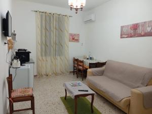a living room with a couch and a table at Elico Di Sicilia home B in Sambuca di Sicilia