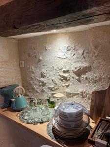 a shelf with a bunch of plates and glasses on it at Moulin insolite - Rooftop - Proche St-Emilion in Saint-Vincent-de-Pertignas +19 photos