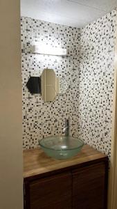a bathroom with a glass bowl sink on a counter at Maison 2 couchages - parking in La Chaussée-sur-Marne