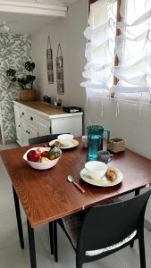 a wooden table with two plates of food on it at Maison 2 couchages - parking in La Chaussée-sur-Marne +11 photos