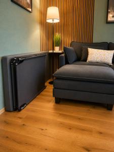 a living room with a couch and a television at Haus Madeleine in Schönwald