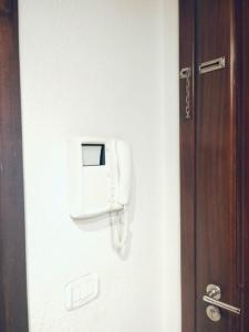 a phone on a wall next to a door at belle appart de luxe CUN in Tunis