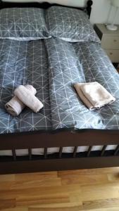 a bed with two towels on the bottom of it at Domek Augustów Monika in Augustów