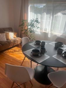 a living room with a black table and chairs at Domek Augustów Monika in Augustów