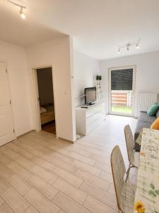 a living room with a couch and a tv at Ametystowa Street in Września