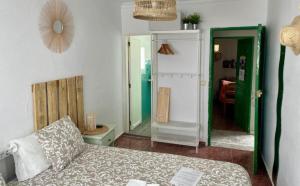 a living room with a couch and a mirror at Pensión Playa in Puerto de Mogán