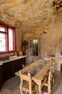 a dining room with a large wooden table in a stone room at Midgard in Osiecznica