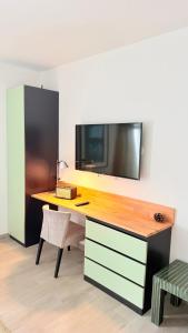 a desk with a television on a wall at O Tourinho Ferrel in Ferrel