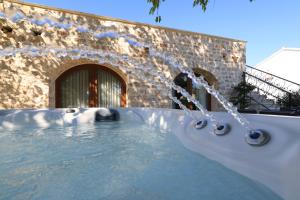 a hot tub in front of a stone building at Filindvor in Nin