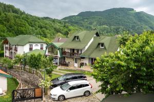 a group of houses with cars parked in front of them at Rooms and apartmants Mirovic in Kolašin