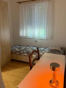 a small room with a table and a window at gvero apartments in Prilep