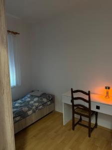a bedroom with a desk and a chair and a bed at gvero apartments in Prilep