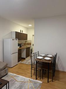 a kitchen and dining room with a table and chairs at gvero apartments in Prilep