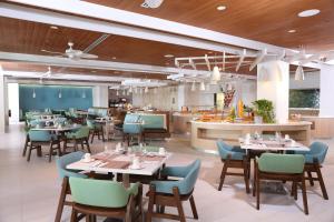 a restaurant with tables and chairs and a kitchen at Warwick Paradise Island Bahamas - All Inclusive - Adults Only in Nassau