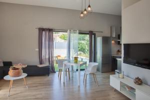 a living room with a table and chairs and a kitchen at Casa Sol location de vacances indépendante à Calvi moins de 2km plage in Calvi +22 photos