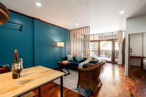 a living room with a couch and a table at BlueHome Apartment in Vientiane