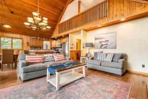 a living room with two couches and a table at Lake Bear Lair in McHenry