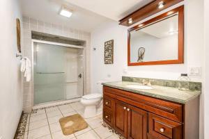 a bathroom with a sink and a toilet and a mirror at Lake Bear Lair in McHenry +45 photos