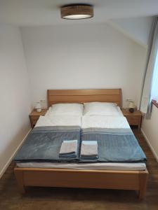 a bed in a room with two towels on it at Apartmán Štiavnik in Vysoké Tatry
