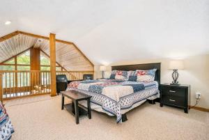 a bedroom with a bed and a table in a room at Lake Bear Lair in McHenry