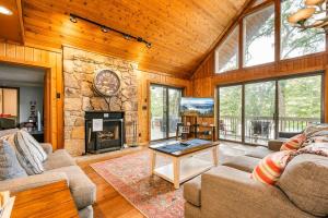 a living room with a fireplace and a stone wall at Lake Bear Lair in McHenry