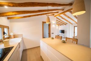 a kitchen with white counters and wooden ceilings at El Planet - Apartamento con terraza in Benimantell