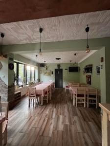 a dining room with pink tables and chairs at Musical Pansion Radgost, Rtanj in Rtanj